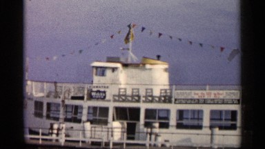 1960: large ship color white sailing in the ocean with triangle small flags