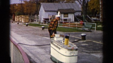 1960: a person dragging a miniature ship away on the road. MICHIGAN