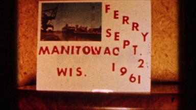 1960: a name board in white letter red color next harbor stop the big ship come