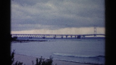 1960: a long bridge that is going over water. MICHIGAN