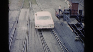 People Observing a Car Going Backward on a Rail Track in Michigan