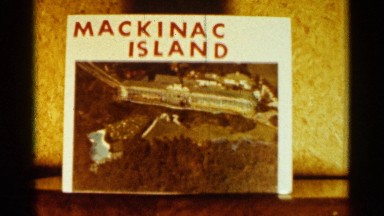 1960: a large building on the coast of mackinac island is surrounded by trees