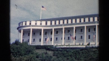 1960: Multiple American Flags Displayed in Front of a Stately Building
