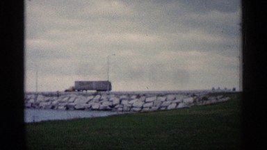 1960: river near green grasses right side big bridge for road