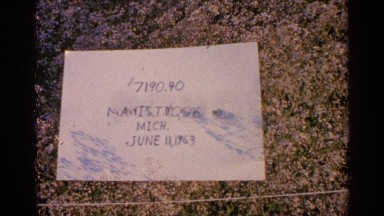 1960: white paper with writing on it placed on a colorful surface