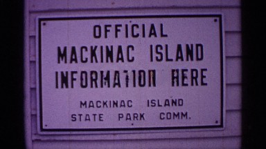 1960: sign saying "official mackinac island information here"