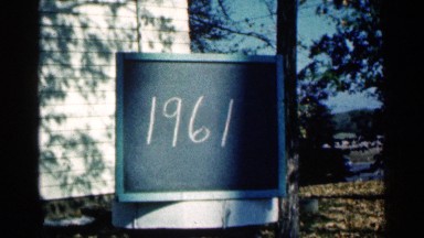 1961: a sign showing the year on a chalkboard plaque