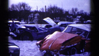 1961: many cars pushed inside icy place where surrounded by trees MINNESOTA