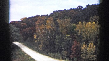 1961: shimmering roadway passes through the woodlands. MINNESOTA