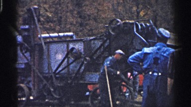 1961: people working by large vehicles in wooded region. MINNESOTA