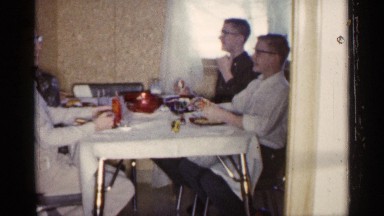 1961: home video of people eating at a table. MINNESOTA
