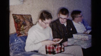 1961: family member opens up his birthday present. MINNESOTA