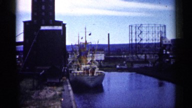 Grand Ship View of a Big One in Harbor on Side of River Near Many