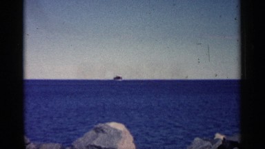 1961: a river with full of water and some stones a ship traveled long with sky