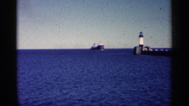 1961: A Massive Ship Arrives at Harbor Next to Lighthouse Minnesota