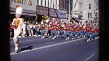 1961: a funny march walk on the road of a city