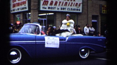 1961: a woman stop the car top side sitting all people give the shake