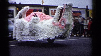 1961: a car back to connect big size doll go to the road in slow drive