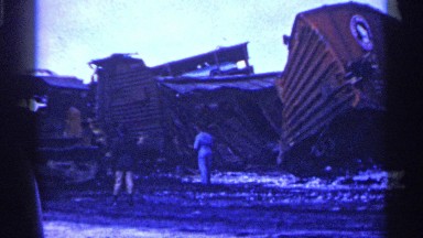 1961: People Witnessing Removal of Large Train Wreck with Crushed Carts