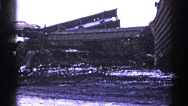 1961: a man walks through the rubble of cars and twisted steel MINNESOTA