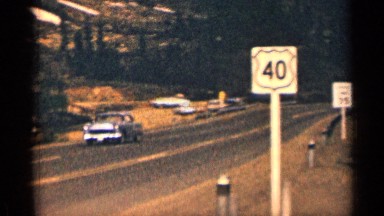 1963: the view of low angle view road run the car near sign board another place
