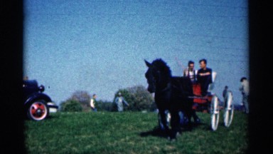 1963: at a open garden or vacation place two men are moving at a horse transport