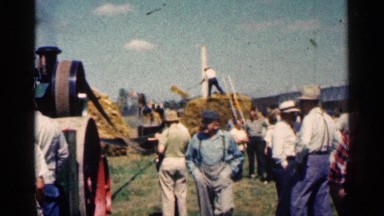 1963: farmers observe the use of a new harvesting machine. MONTGOMERY MINNESOTA