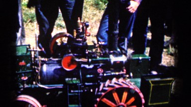 1963: a group of men stand around a stationary locomotive machine