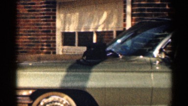 1963: man carrying objects from car to a building. TENNESSEE