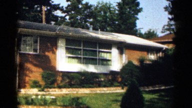 1963: a big house near to car in parking back side big tree wood front side