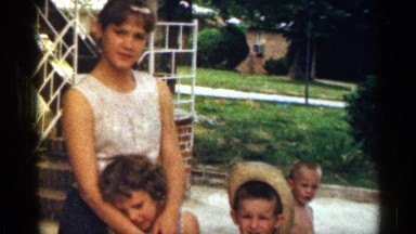 1963: Girl and Three Small Children Near Man by Bridge in Texas