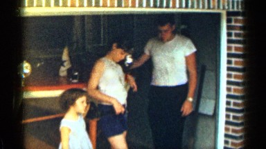 1963: Father Inspects Youngest Daughter's Gown in Texas Garage