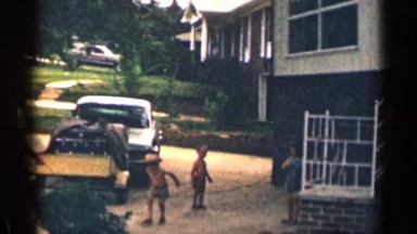 1963: cute little kids playing on the porch with their father. TEXAS