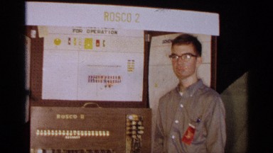 1963: boy showing off stands in front of a rosco 2 machine during an event TEXAS