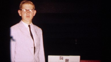 1963: a young citizen stands near a table with a small display of items. TEXAS