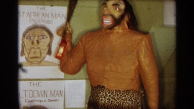 1963: human evolution chart and a dummy model of ancient human in an indoor