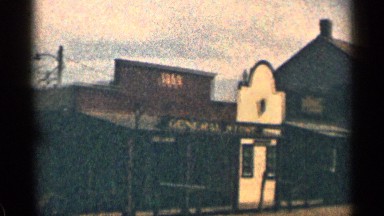 1963: long line of commercial building on the row, on a sunny day. WYOMING