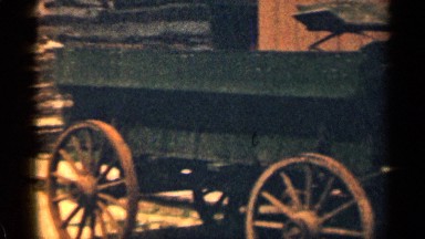 1963: wagon parked in front of a building. WYOMING COLORADO