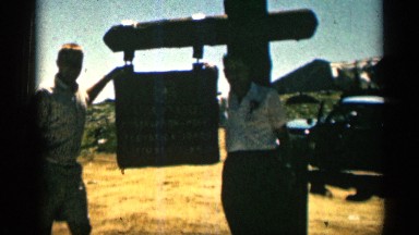 1963: Two Men Posing by Wooden Signpost in Wyoming