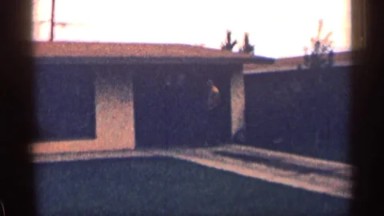 1963: Man Pulling Down Garage Door After Taking Car Out, Wyoming
