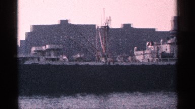 1964: large ocean vessel slowly sails by in the water