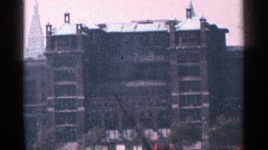 1964: bulky and dark building has recessed exterior between extended towers