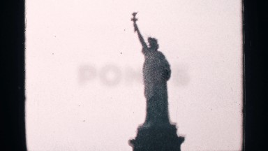 1964: A Statue Standing Alone Holding a Symbol in Her Hand