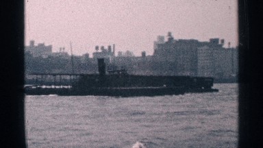 1964: boat transporting containers down river in city location NEW YORK CITY