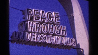 1964: sign hanging in archway followed by water fountains. NEW YORK CITY