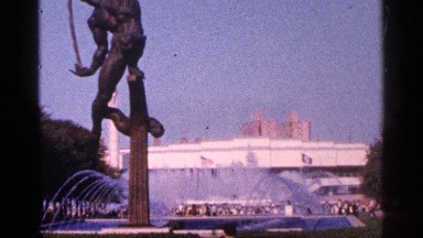 1964: fountain in front of a white building with a bronze statue in the