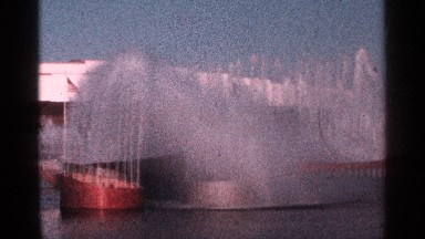 1964: young man watching a very large fountain display in a lake NEW YORK CITY