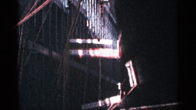 1964: a person is seen walking from the gangway of a ship onto a stone structure