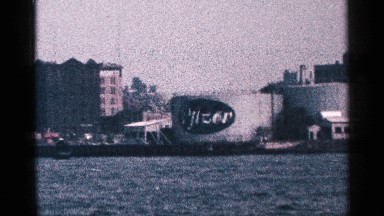 1964: shown with the building and sea and trees of the city. NEW YORK CITY