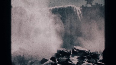 1964: Man Watching the Heavy Fast Falls at Niagara Falls Canada